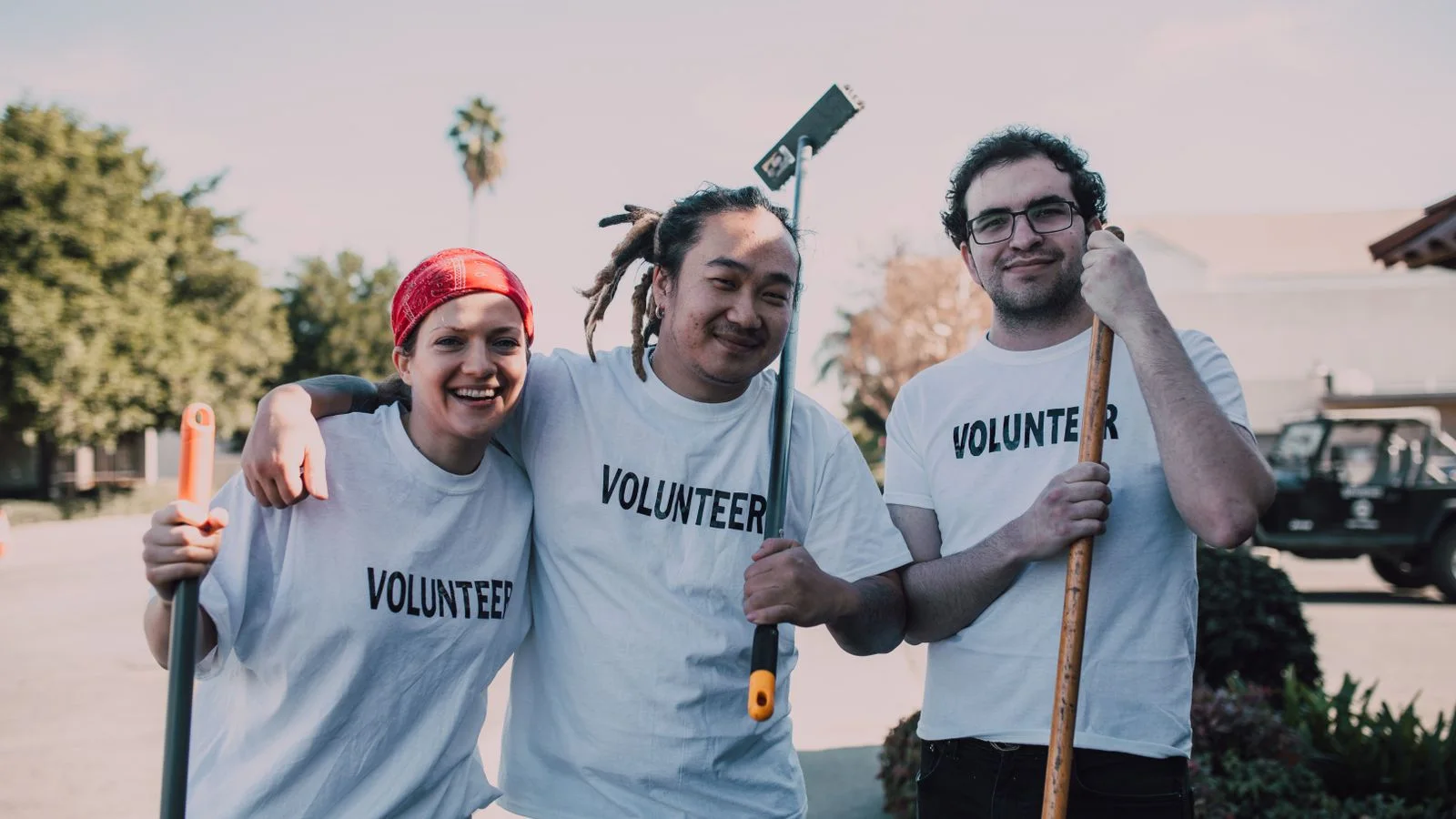 Frivillige i hvide trøjer samarbejder ved et arrangement